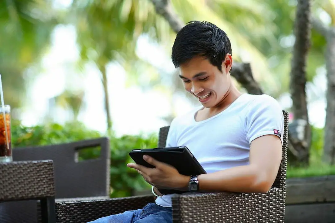 young smiling man with tablet