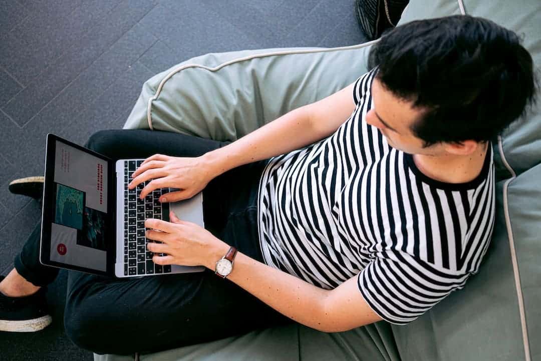 a man typing on laptop