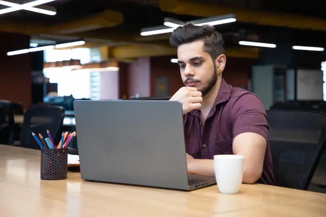 a person sitting in front of the laptop