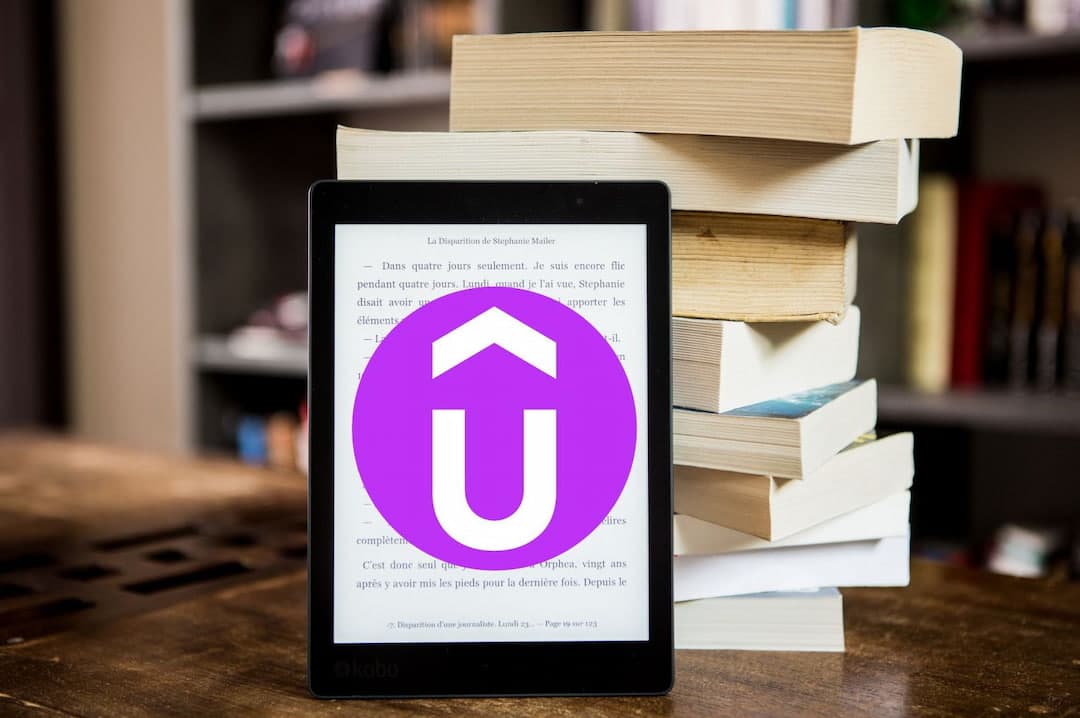 notebook with Udemy logo and the books behind it